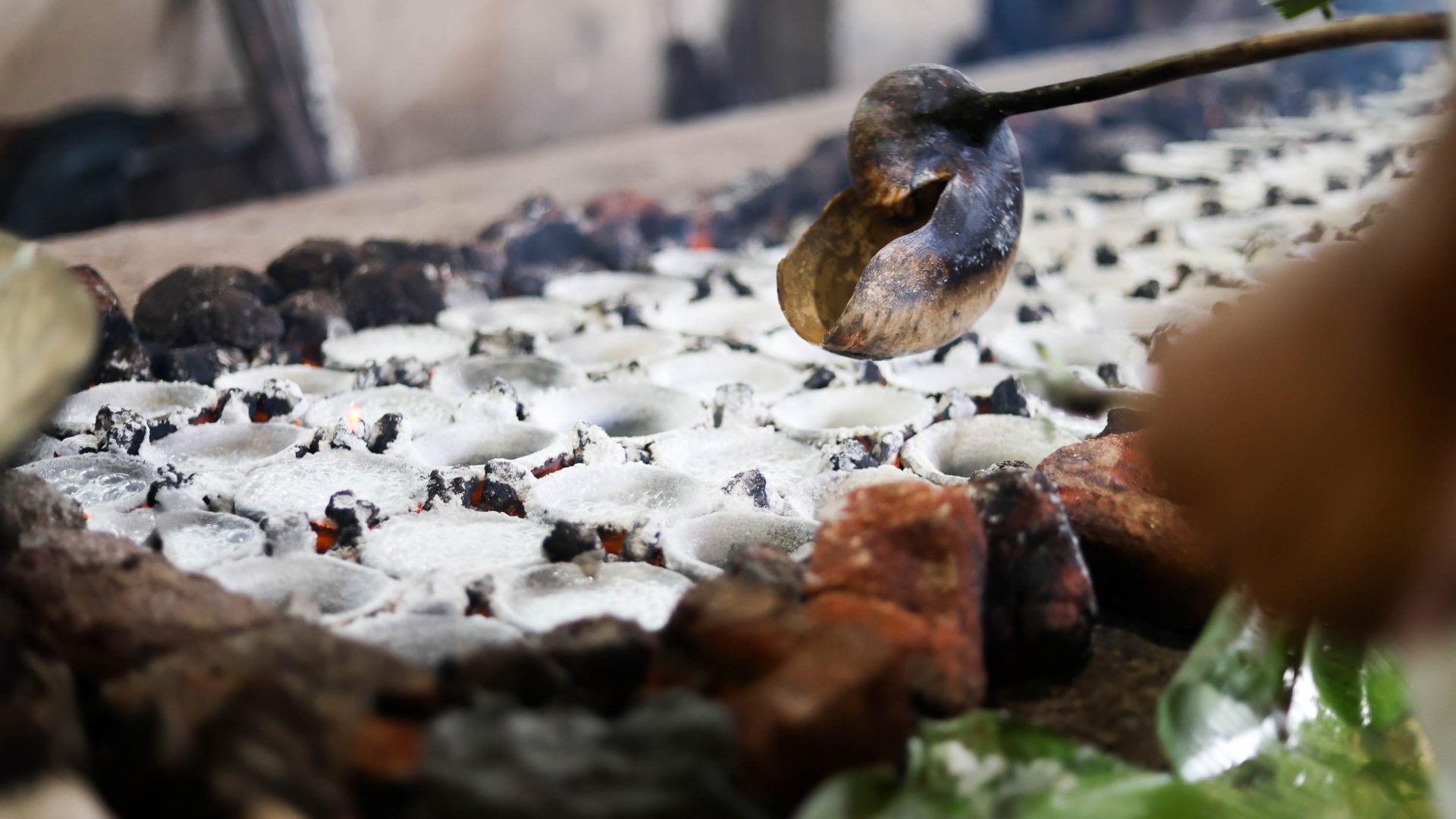 A ladle carefully reaches for a ball of salt.