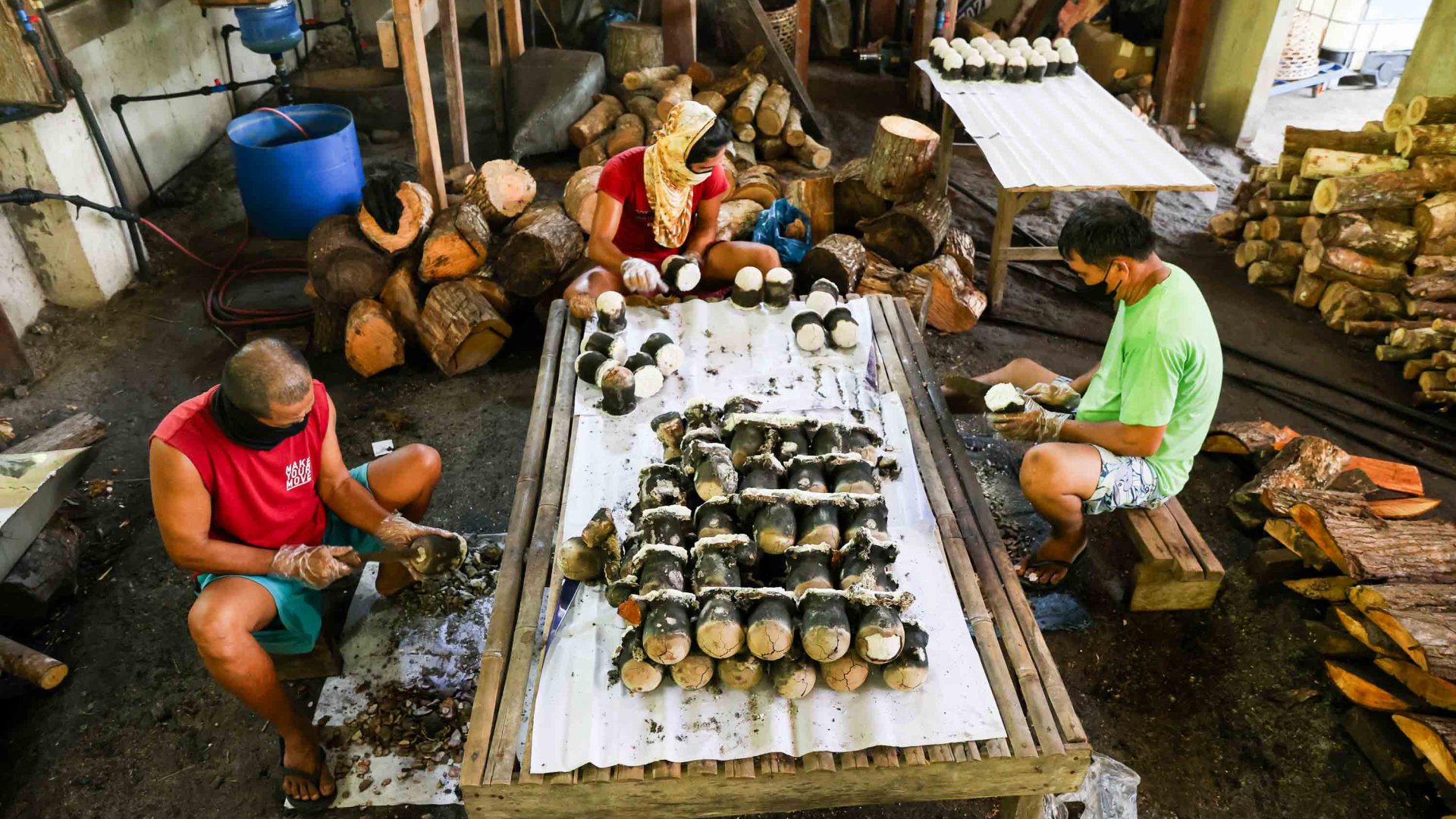 Men sit around a table laid out with salt.