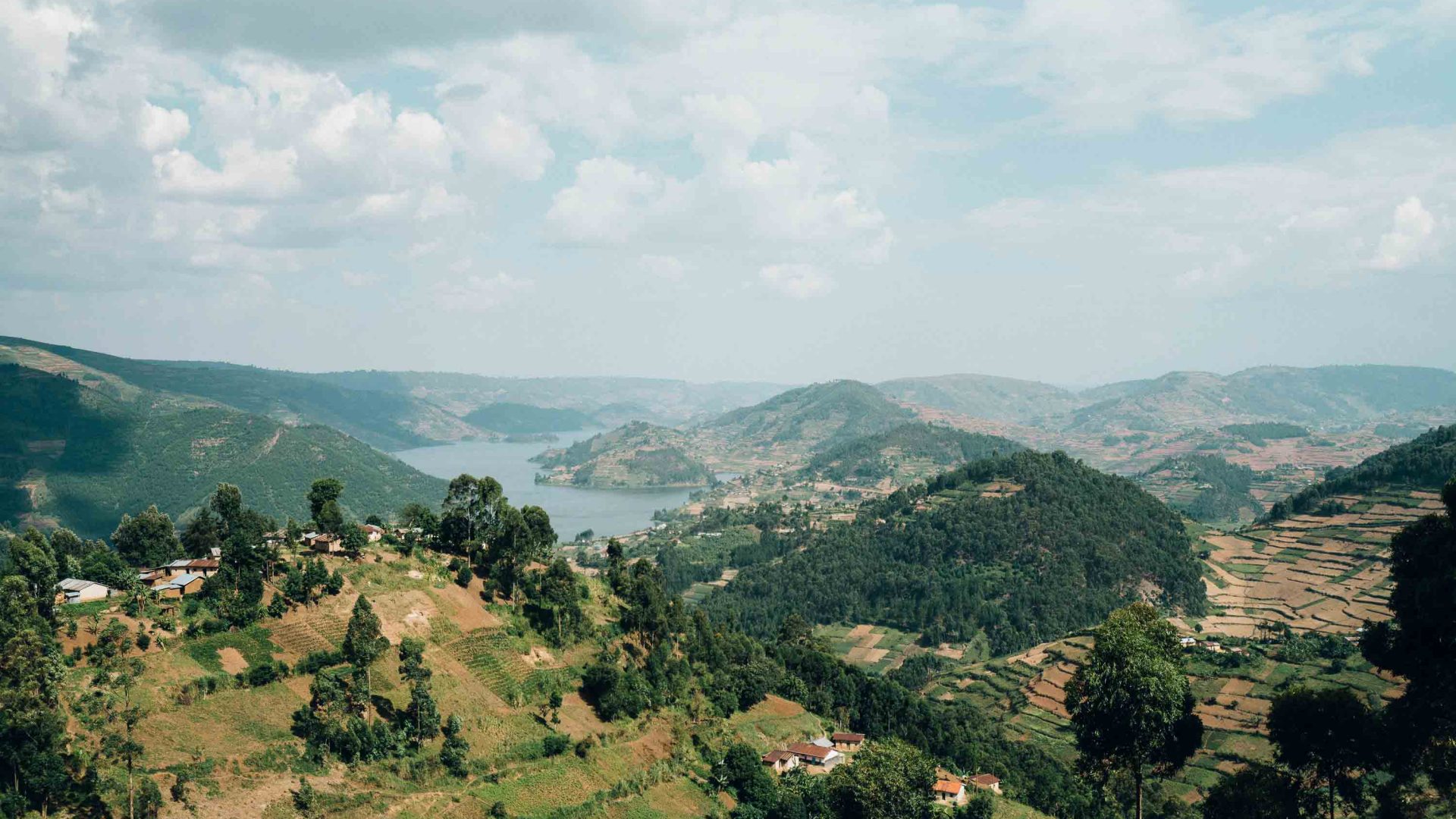 Green hills lead to a lake.