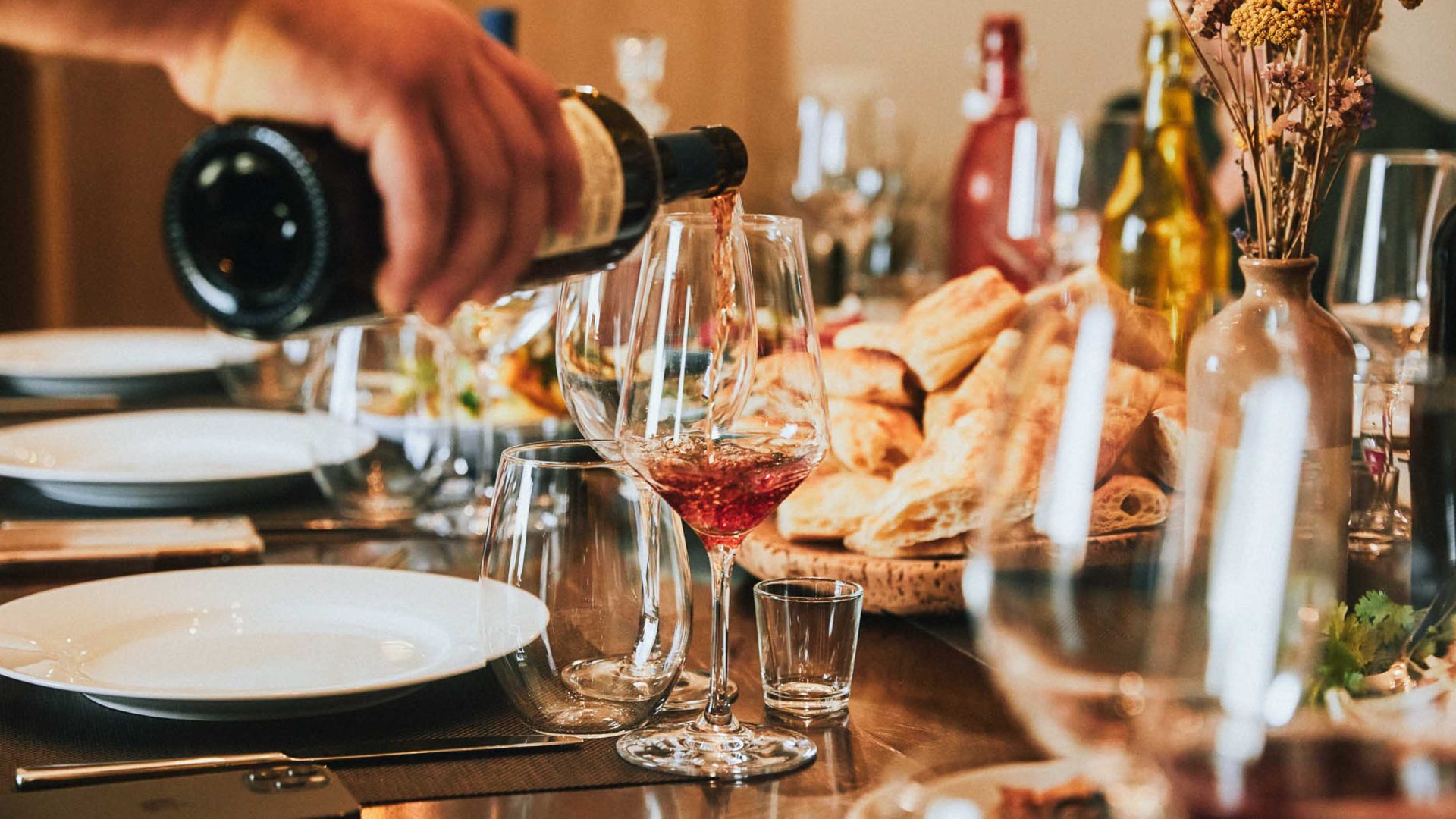 A person pours a glass of wine.