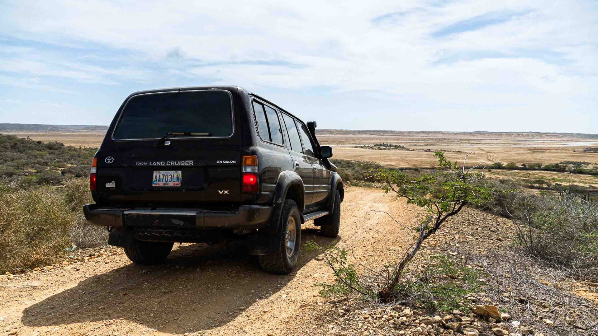 A 4WD for tourists on the dirt road.