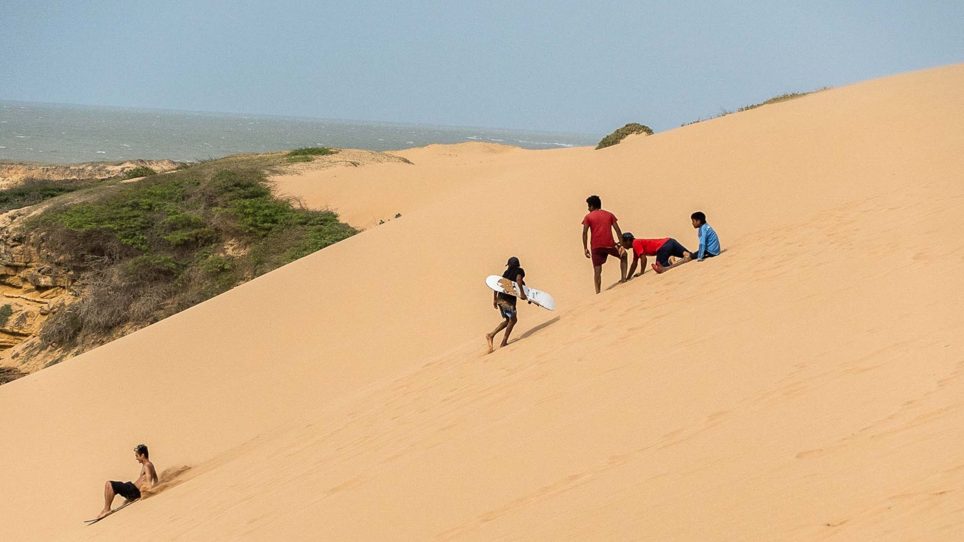 People sandboarding at Dunas de Taroa.