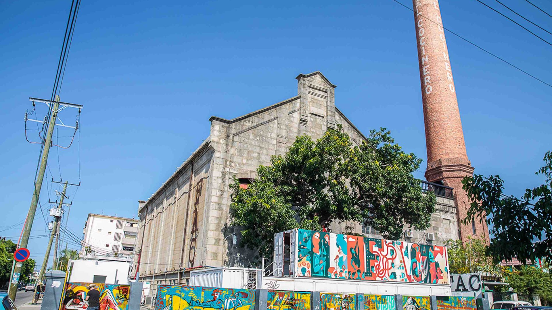 A big building with street art on the exterior walls.