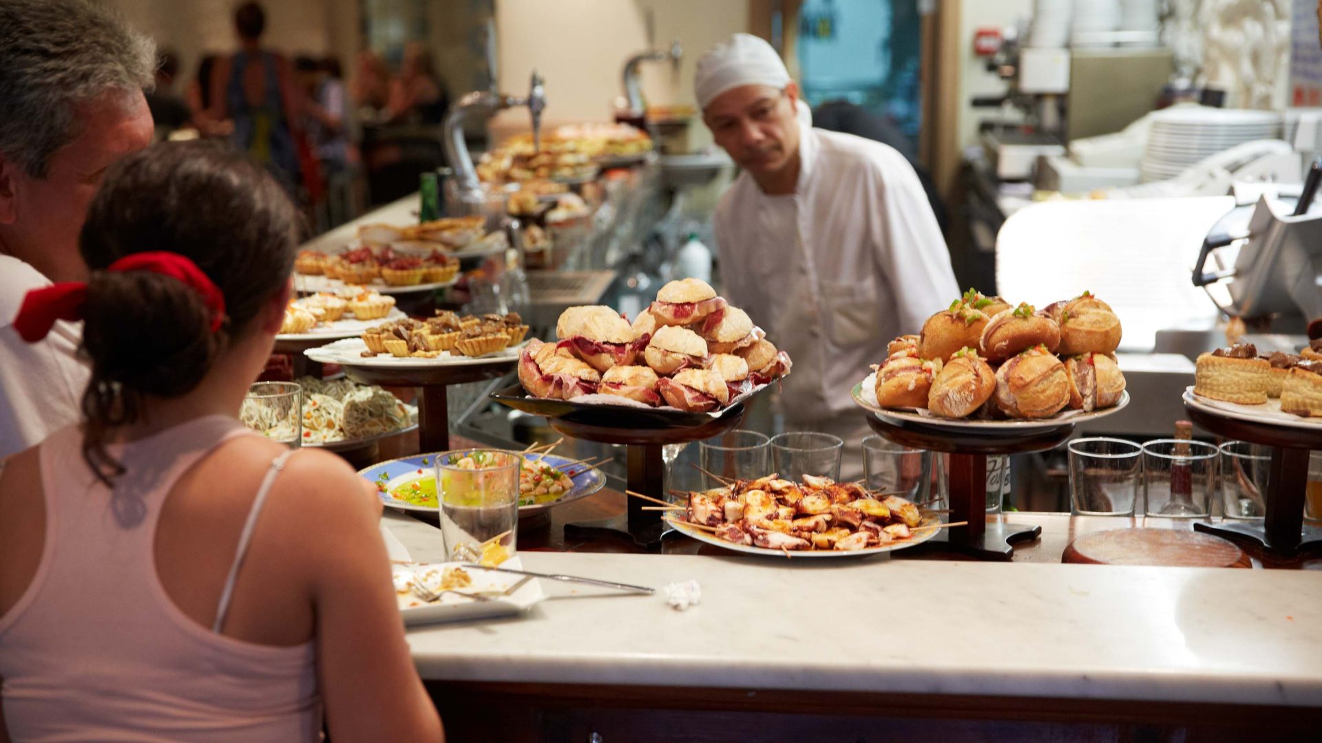 A typical Basque eatery with plates of pintxos among other things.