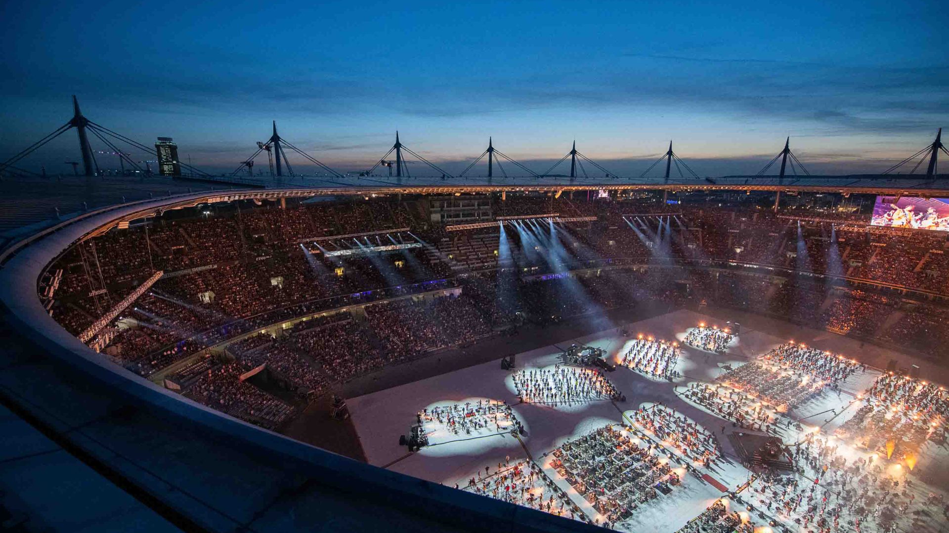 The Stade de France filled with people, lit up at night.