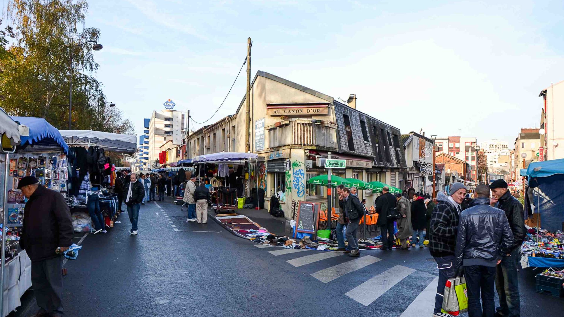 People and stalls at a market.