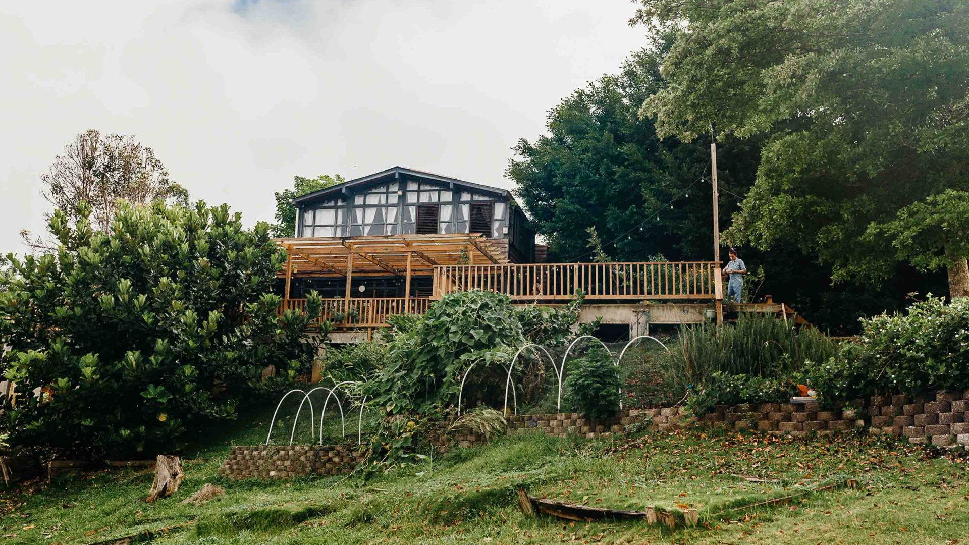 A building surrounded by farm and gardens.