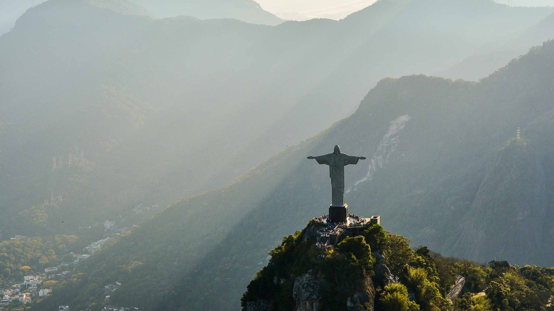 Christ the Redeemer stands on a hill overlooking Rio De Janeiro.