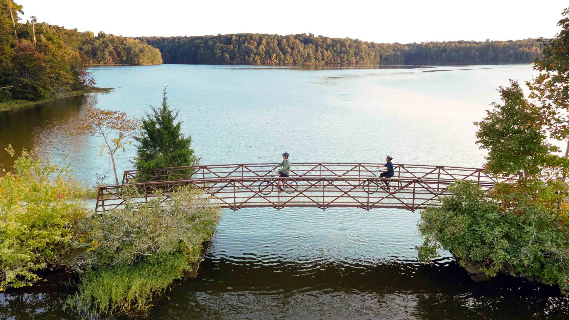 Bikers cross Salem Lake bridge.