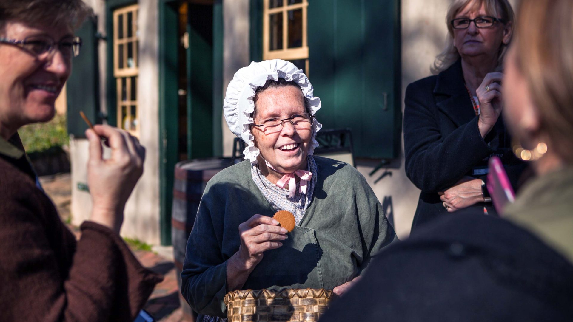 Sister Deb talks with visitors while enjoying a cookie.