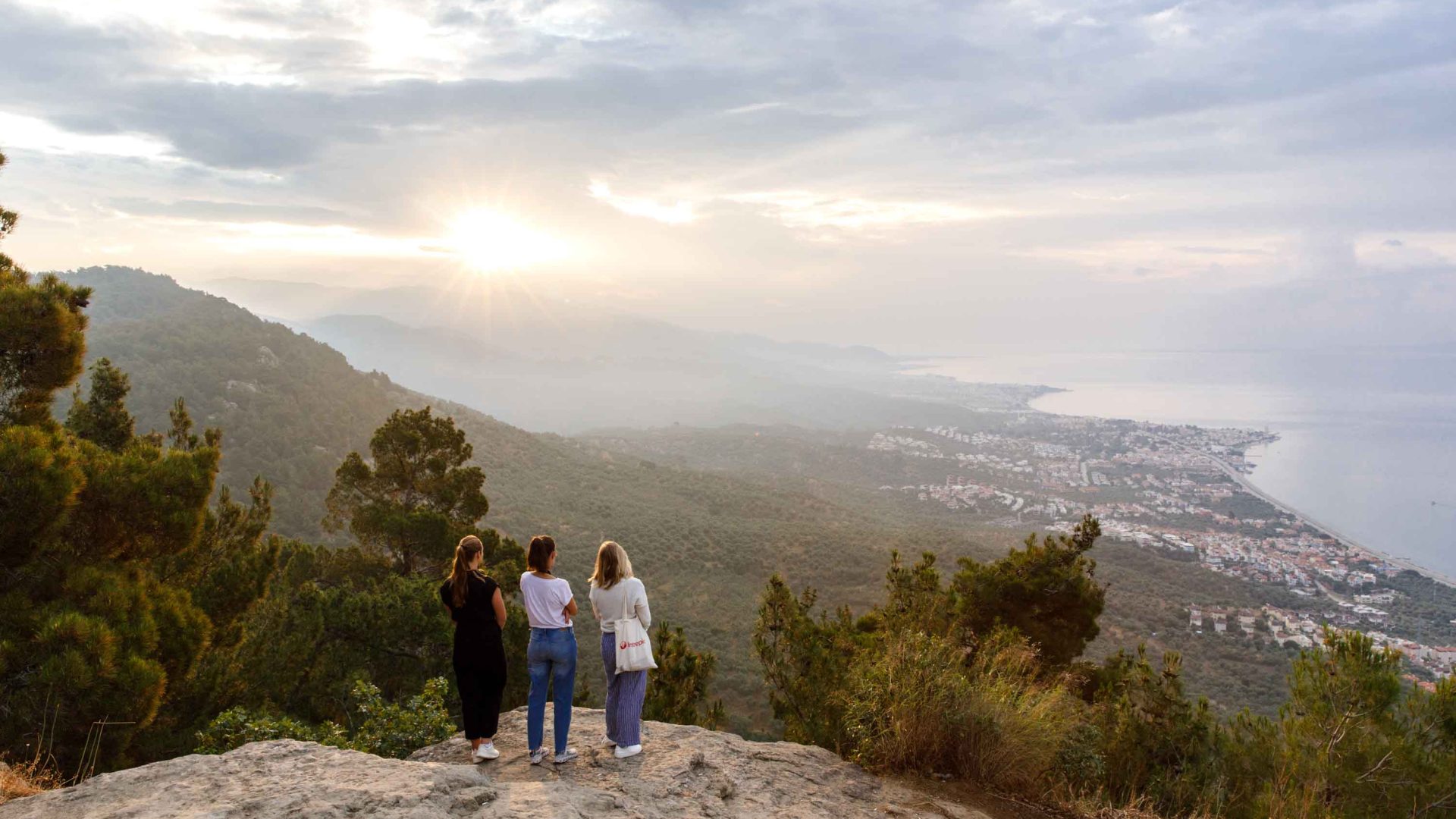 Two travelers look out at Adatepe at sunrise from Altar of Zeus.